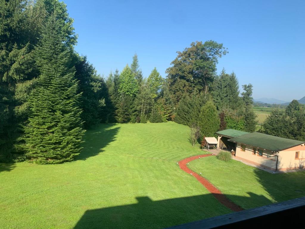 The view from an upper window: the lawn, the trees and hills on the horizon